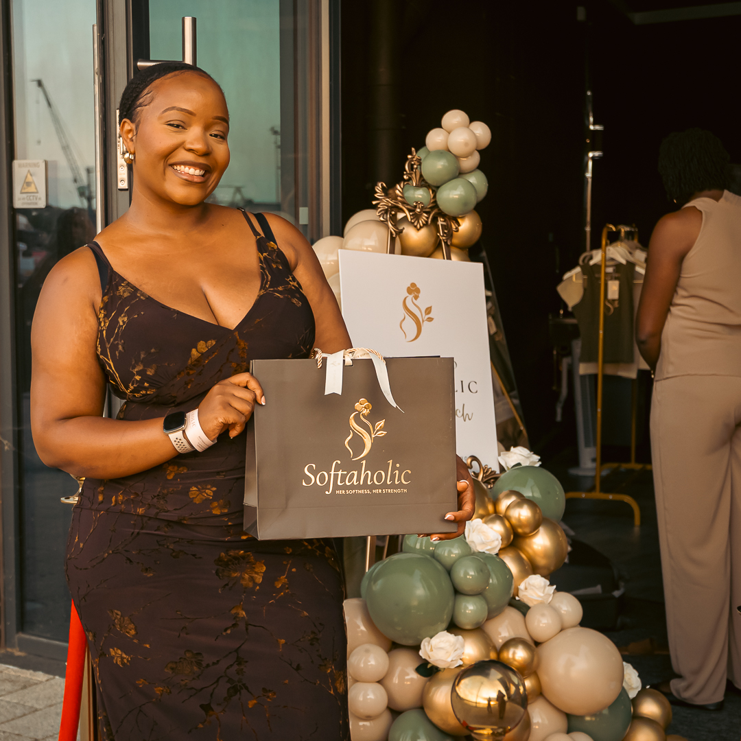 Guest holding a Softaholic gift bag at the launch